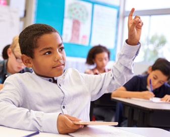 Student in class raising his hand