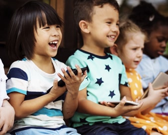 Smiling students holding phones