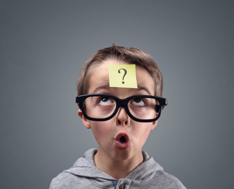 boy with question mark sticky note on his forehead