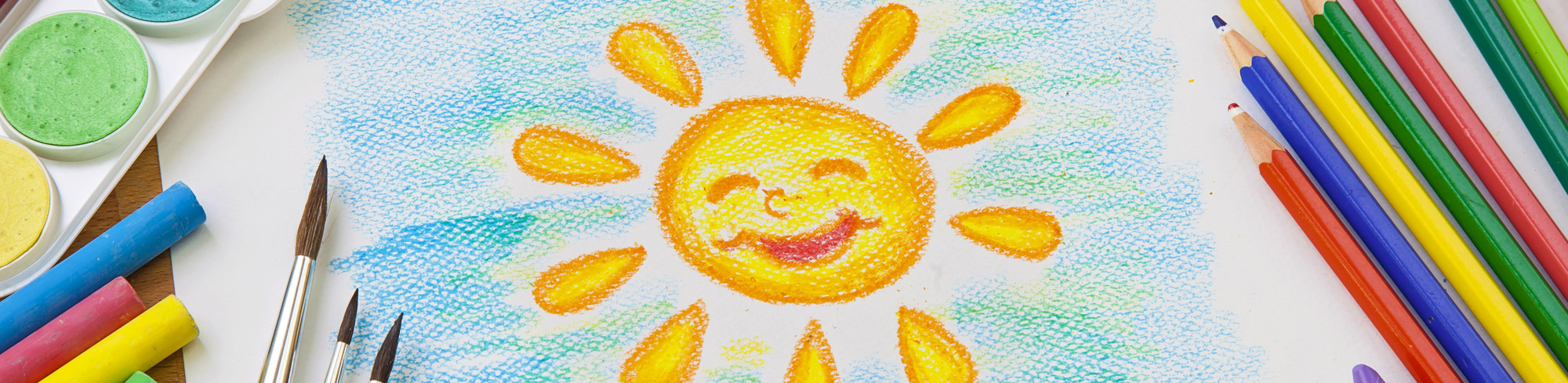 school supplies next to a colored sun