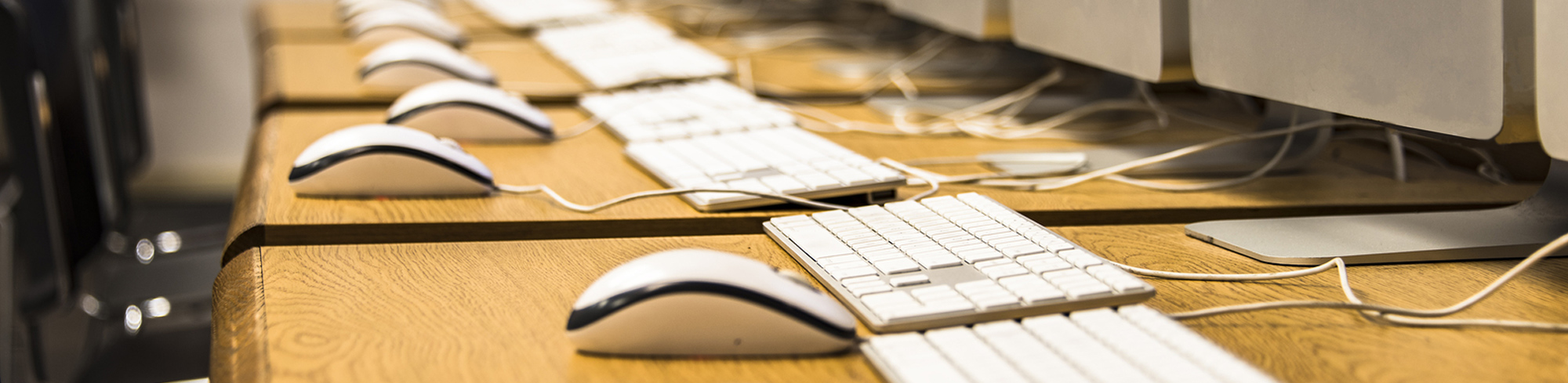 tables with electronic workstations set up in a long row