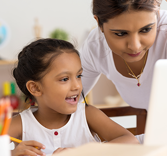 An adult helping a child with school work