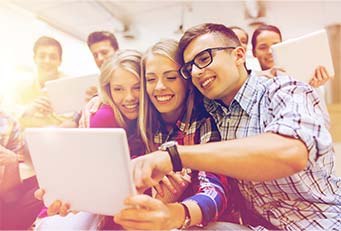Students looking at a tablet together