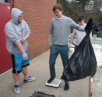 Students taking out trash