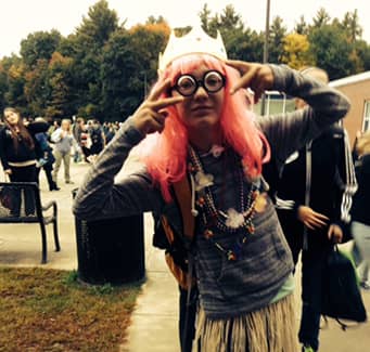Student wearing a wig and silly glasses