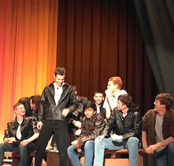 Theater group performing in leather jackets