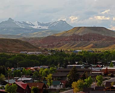 scenic view of a town with mountains behind it