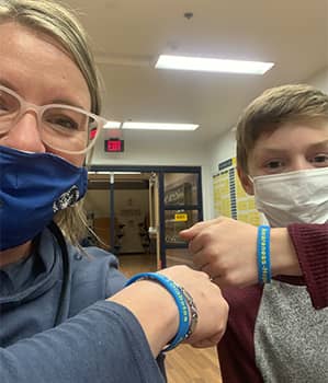 school nurse and student with face masks on