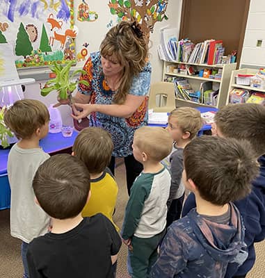 pre-k students learning about a green plant