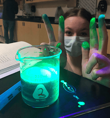 Student doing glow in the dark science