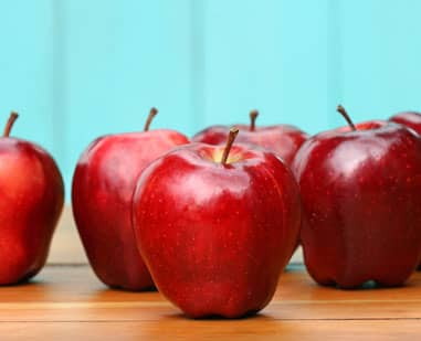 red apples sitting on a desk