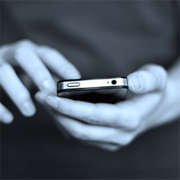 Hands holding a cell phone