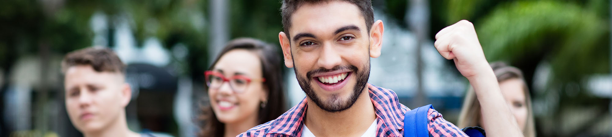 Young male adult smiling outside after a great accomplishment