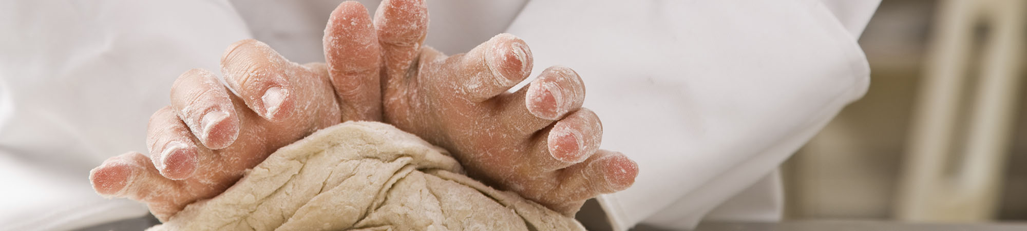 Culinary student kneading dough