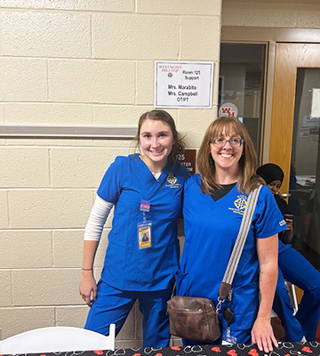 Nursing student next to a teacher