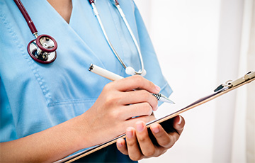 Nurse writing in a chart