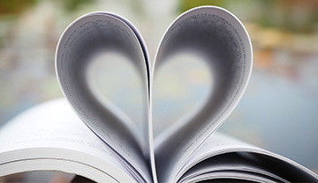 Book opened with pages folded in the shape of a heart