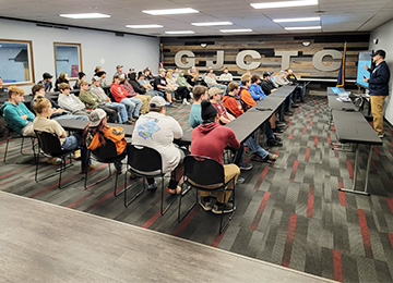 Students in an auditorium listening to a presentation