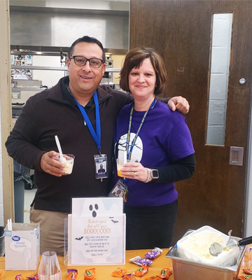 Two staff members enjoying a Halloween event