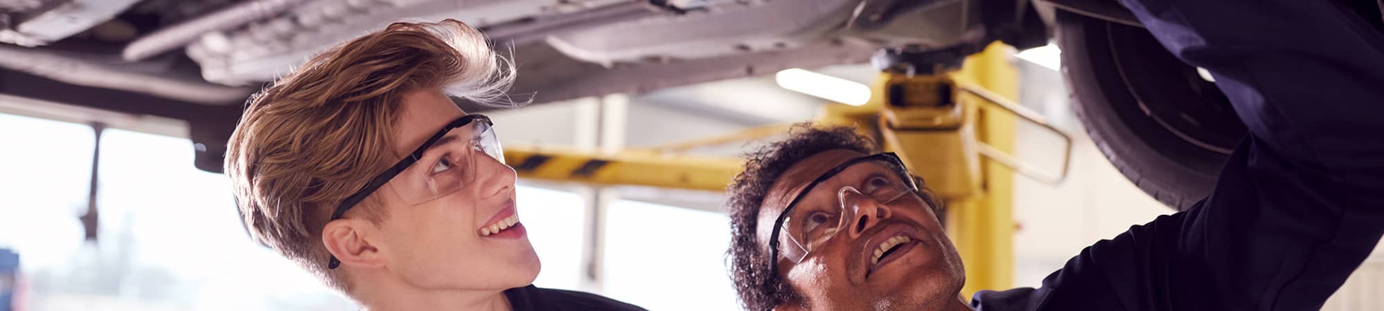 People looking under a car