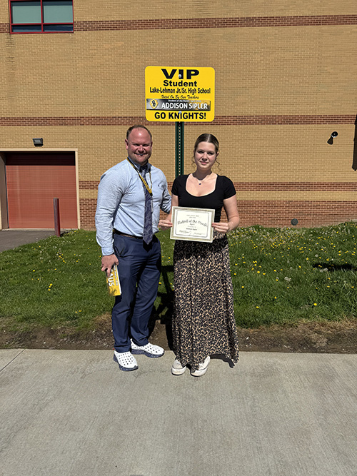Principal with student of the month outside
