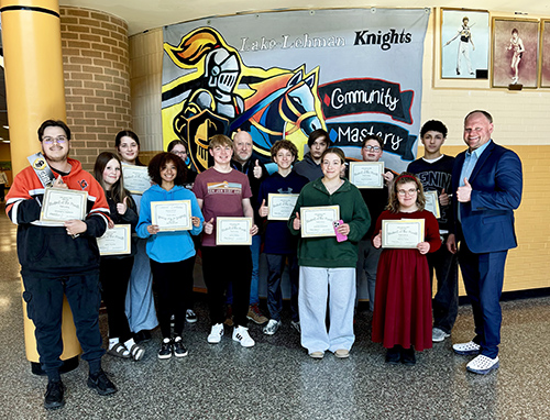 Group of students holding up student of the month certificates for February 2026