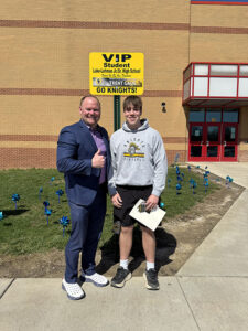 Principal with male student of the month for March 2026