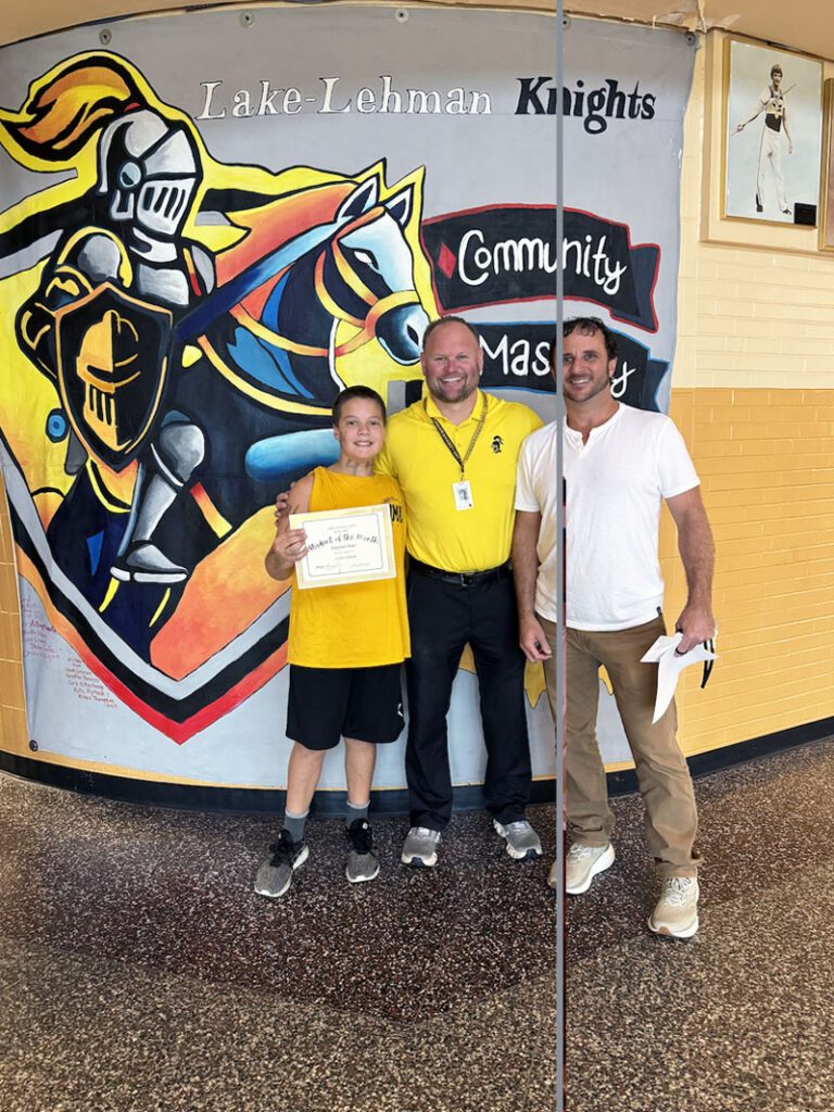 Teacher of the Month for September 2026 with student and principal