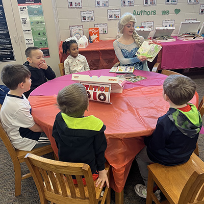 Elsa reading to kids
