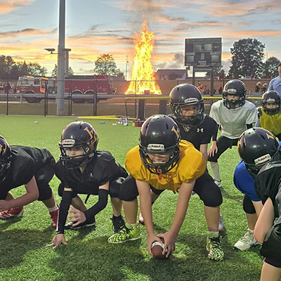 younger students playing football