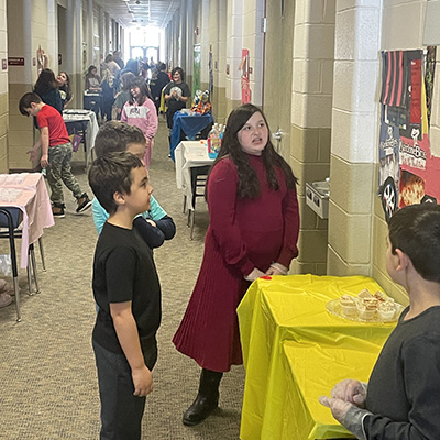 kids visiting different tables set up with presentations