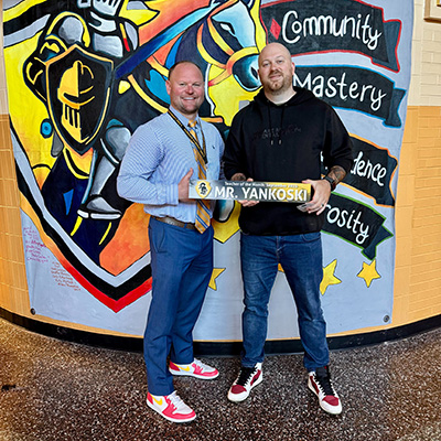 two men holding a sign