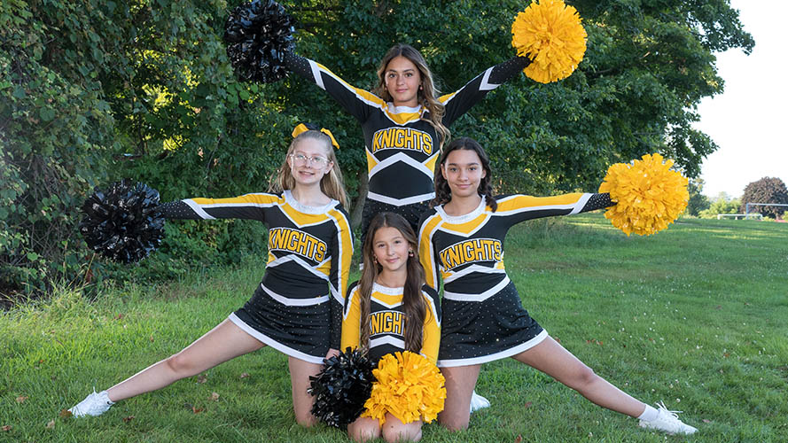 Four cheerleaders posing for a picture
