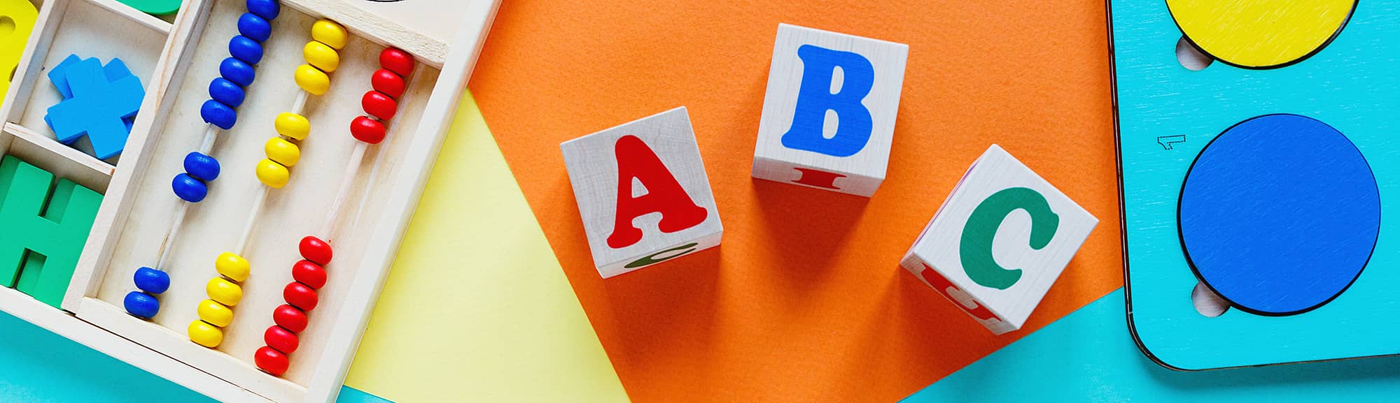 colorful letter blocks, paints, and and shapes