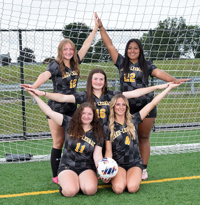 Soccer girls with their arms in the shape of a star