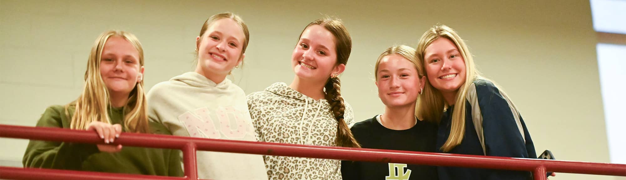 Four girls at a railing
