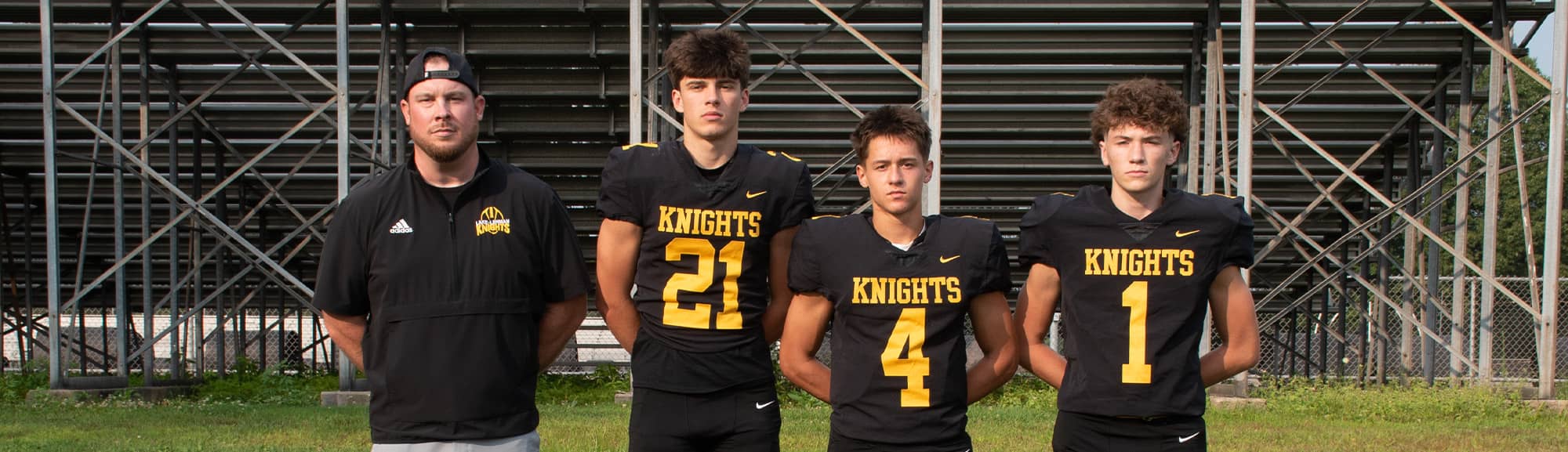 Three football players and coach