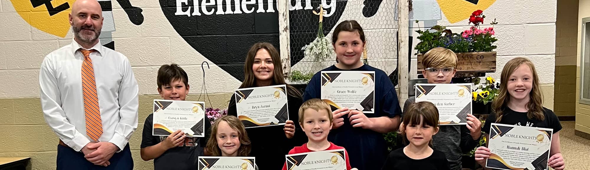 Ross elementary students holding awards