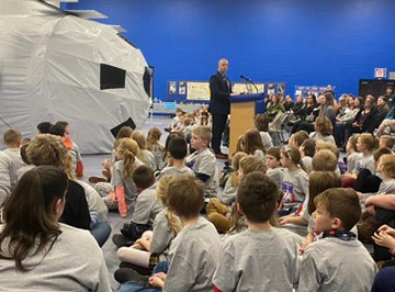 Adult talking to students about NASA