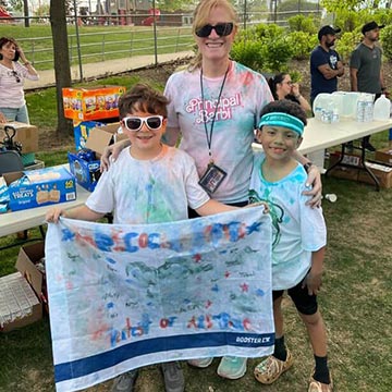 Students and teacher covered in colored chalk for an event