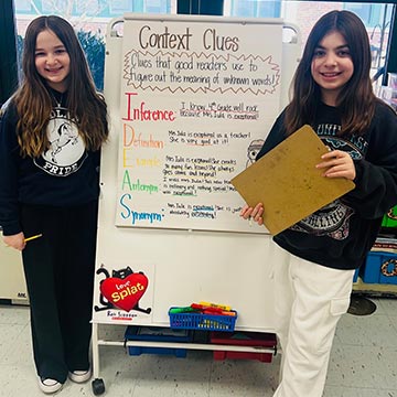 Two students giving a presentation about context clues Two students giving a presentation about context clues