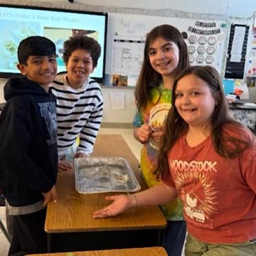 Students displaying a project in class