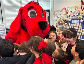 Students hugging a Clifford mascot