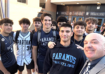 Group of happy students with principal on the first day of school