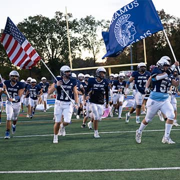 Notebook on desk in the classroom Cup of coffee with a heart shape in the foam
