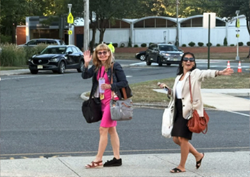 Two happy staff members walking into work