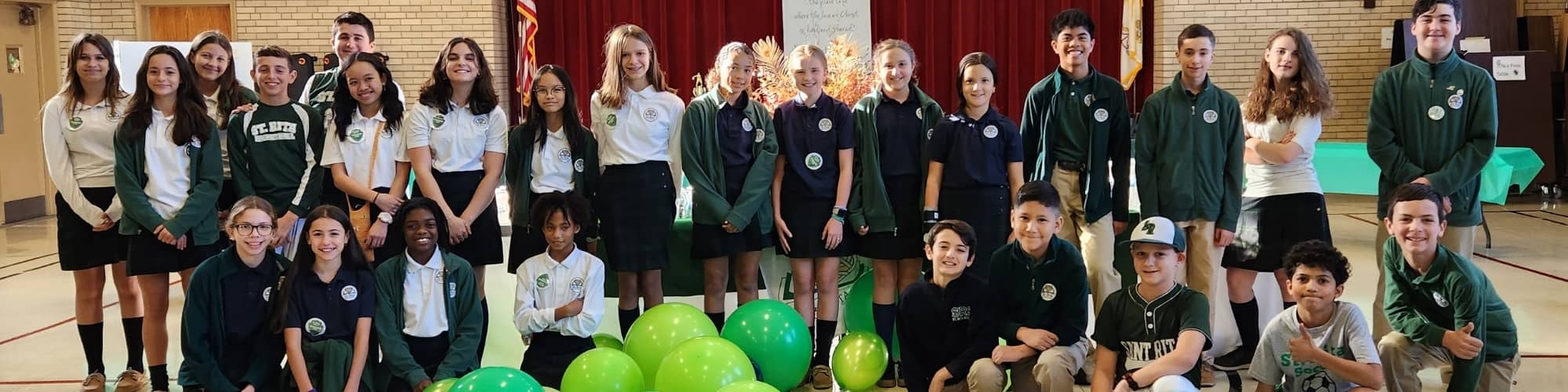 group photo of students behind balloons
