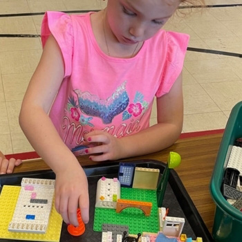 Student working with Lego set