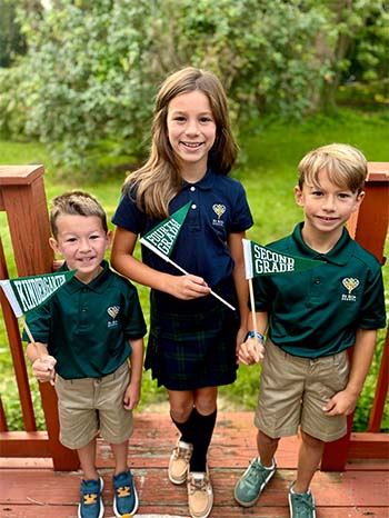 Three students on a porch
