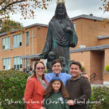 Family standing in front of a statue